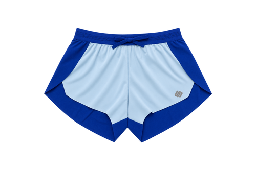 A pair of athletic shorts in a colorblock design of royal blue and light blue, featuring a drawstring waistband and a small metallic logo on the lower left leg, shown against a plain white background.